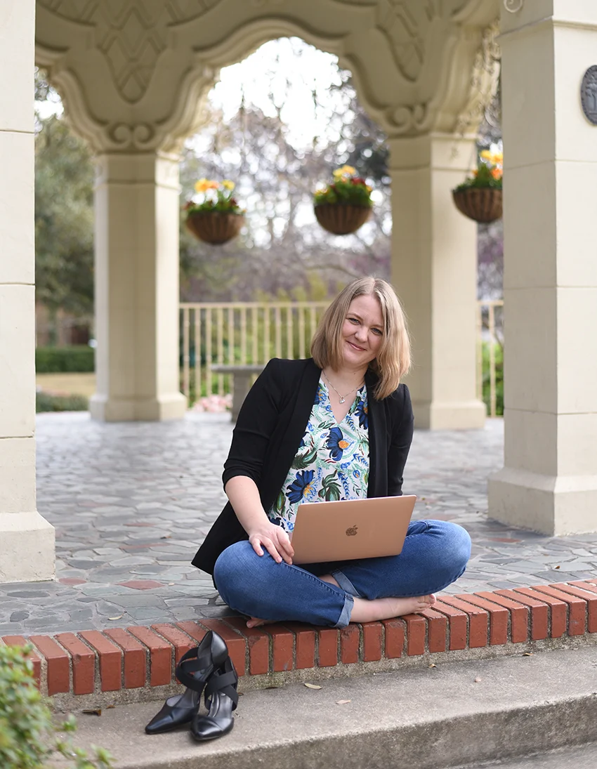 Genia Bowyer sitting with her laptop
